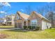 Side view of a charming two-story house with stone and siding, two-car garage at 2242 Colorado Dr, Graham, NC 27253