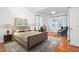 Relaxing main bedroom with hardwood floors, light blue curtains, and natural light from a window at 2242 Colorado Dr, Graham, NC 27253