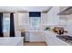 White kitchen with stainless steel appliances and a large island at 246 Tidal Pool Way, Cary, NC 27519