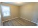 Small bedroom with hardwood floors and a window at 248 Southgate Dr, Garner, NC 27529