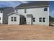 Back exterior view of new construction home with gray siding and ample windows at 250 Tidal Pool Way, Cary, NC 27519
