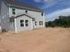 Back exterior view of new construction home with gray siding and ample windows at 250 Tidal Pool Way, Cary, NC 27519