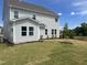 The backyard features a newly installed lawn and exterior view of home with neutral-toned siding at 250 Tidal Pool Way, Cary, NC 27519