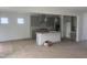 A bright open-concept kitchen with an island, gray cabinets, and stainless steel appliances at 250 Tidal Pool Way, Cary, NC 27519
