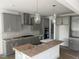 A modern kitchen with gray cabinets, stainless steel appliances and a subway tile backsplash at 250 Tidal Pool Way, Cary, NC 27519