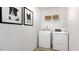 Bright laundry room, washer, dryer, and shelving at 265 Sweetbay Tree Dr, Wendell, NC 27591
