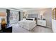 Luxurious main bedroom featuring a large bed, a statement wall, and plenty of natural light at 265 Sweetbay Tree Dr, Wendell, NC 27591