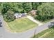 Charming home featuring solar panels, a front porch, a spacious yard and driveway with mature trees at 326 W Bywood Dr, Durham, NC 27712