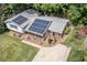Aerial view of the home with solar panels, driveway, and landscaping at 326 W Bywood Dr, Durham, NC 27712