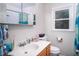 Bright bathroom features a vanity with sink, toilet, and natural light at 326 W Bywood Dr, Durham, NC 27712
