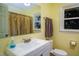 Bathroom featuring yellow walls, a shower with curtain, and ample natural light at 326 W Bywood Dr, Durham, NC 27712