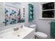 Clean bathroom with a white vanity, updated fixtures, and a decorative shower curtain at 326 W Bywood Dr, Durham, NC 27712