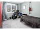 Bedroom includes desk and computer station, electric guitar and black bedding at 326 W Bywood Dr, Durham, NC 27712