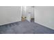 Empty bedroom with gray carpet and doorways leading to other rooms at 326 W Bywood Dr, Durham, NC 27712