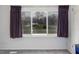 Bedroom has large windows with view of the outdoors and dark curtains at 326 W Bywood Dr, Durham, NC 27712