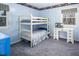 Light blue bedroom features a white bunk bed, white desk with fish tank, and grey carpeting at 326 W Bywood Dr, Durham, NC 27712