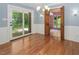 Hardwood dining room featuring glass doors to the backyard and an open doorway to a sunroom at 326 W Bywood Dr, Durham, NC 27712