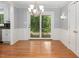 Dining room with hardwood floors, modern chandelier, and french doors to the backyard at 326 W Bywood Dr, Durham, NC 27712