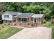 Charming brick home with solar panels, manicured lawn and flower beds at 326 W Bywood Dr, Durham, NC 27712