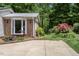 Charming brick house featuring a bay window, lush landscaping, and a concrete driveway at 326 W Bywood Dr, Durham, NC 27712