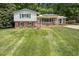 Charming two-story home with brick facade, solar panels, and a well-manicured front lawn at 326 W Bywood Dr, Durham, NC 27712