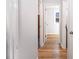 Hallway featuring hardwood floors and fresh paint, connecting various rooms in the home at 326 W Bywood Dr, Durham, NC 27712