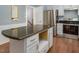 Kitchen featuring a granite island, stainless steel appliances, and wood floors at 326 W Bywood Dr, Durham, NC 27712