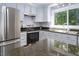 Bright kitchen with stainless steel appliances and dark countertops at 326 W Bywood Dr, Durham, NC 27712
