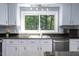 Renovated kitchen featuring white cabinets, stainless steel appliances, and natural light at 326 W Bywood Dr, Durham, NC 27712
