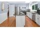 Kitchen with granite island, stainless steel appliances, white cabinets and hardwood floors at 326 W Bywood Dr, Durham, NC 27712