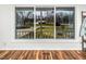 Bright room featuring large windows offering a view of the neighborhood and hardwood floors at 326 W Bywood Dr, Durham, NC 27712