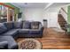 Spacious living room with hardwood floors, a large sectional, and ample natural light at 326 W Bywood Dr, Durham, NC 27712