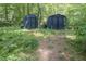 Pair of matching outdoor sheds with a rustic appearance surrounded by lush greenery at 326 W Bywood Dr, Durham, NC 27712