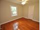 Hardwood floor bedroom with ceiling fan and ample natural light at 326 Webster St, Cary, NC 27511