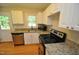Modern kitchen with white cabinets, granite countertops, and appliances at 326 Webster St, Cary, NC 27511