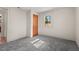 Bedroom with grey carpet, closet and access to kitchen at 3817 Booker Ave, Durham, NC 27713