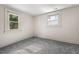 Well-lit bedroom featuring grey carpet and two windows at 3817 Booker Ave, Durham, NC 27713
