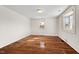 Bright bedroom with hardwood floors and large windows at 3817 Booker Ave, Durham, NC 27713