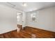 Bedroom with hardwood floors and access to another room at 3817 Booker Ave, Durham, NC 27713