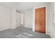 Simple bedroom with grey carpet and closet at 3817 Booker Ave, Durham, NC 27713