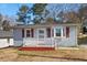 Ranch style home with red shutters, front porch, and brick steps at 3817 Booker Ave, Durham, NC 27713