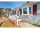 House exterior showcasing a white porch and red shutters at 3817 Booker Ave, Durham, NC 27713