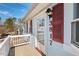 Front entrance with red shutters and white railing at 3817 Booker Ave, Durham, NC 27713