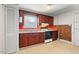 Kitchen with wood cabinets and tile floor at 3817 Booker Ave, Durham, NC 27713