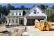New two-story home being built with siding, visible garage, and under construction landscape at 387 E Clydes Point Way, Wendell, NC 27591