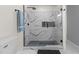 Spa-like bathroom with walk-in shower and marble tile at 420 Nelson St, Durham, NC 27707