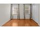 Bright bedroom with hardwood floors and two windows at 420 Nelson St, Durham, NC 27707
