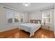 Bedroom with hardwood floors, queen bed and window at 420 Nelson St, Durham, NC 27707