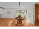 Sunlit dining area with hardwood floors and a round table for four at 420 Nelson St, Durham, NC 27707