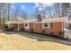 Brick ranch house with mature landscaping and a spacious lawn at 420 Nelson St, Durham, NC 27707